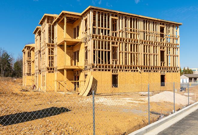 a temporary chain link fence in front of a building under construction, ensuring public safety in Clinton, IN